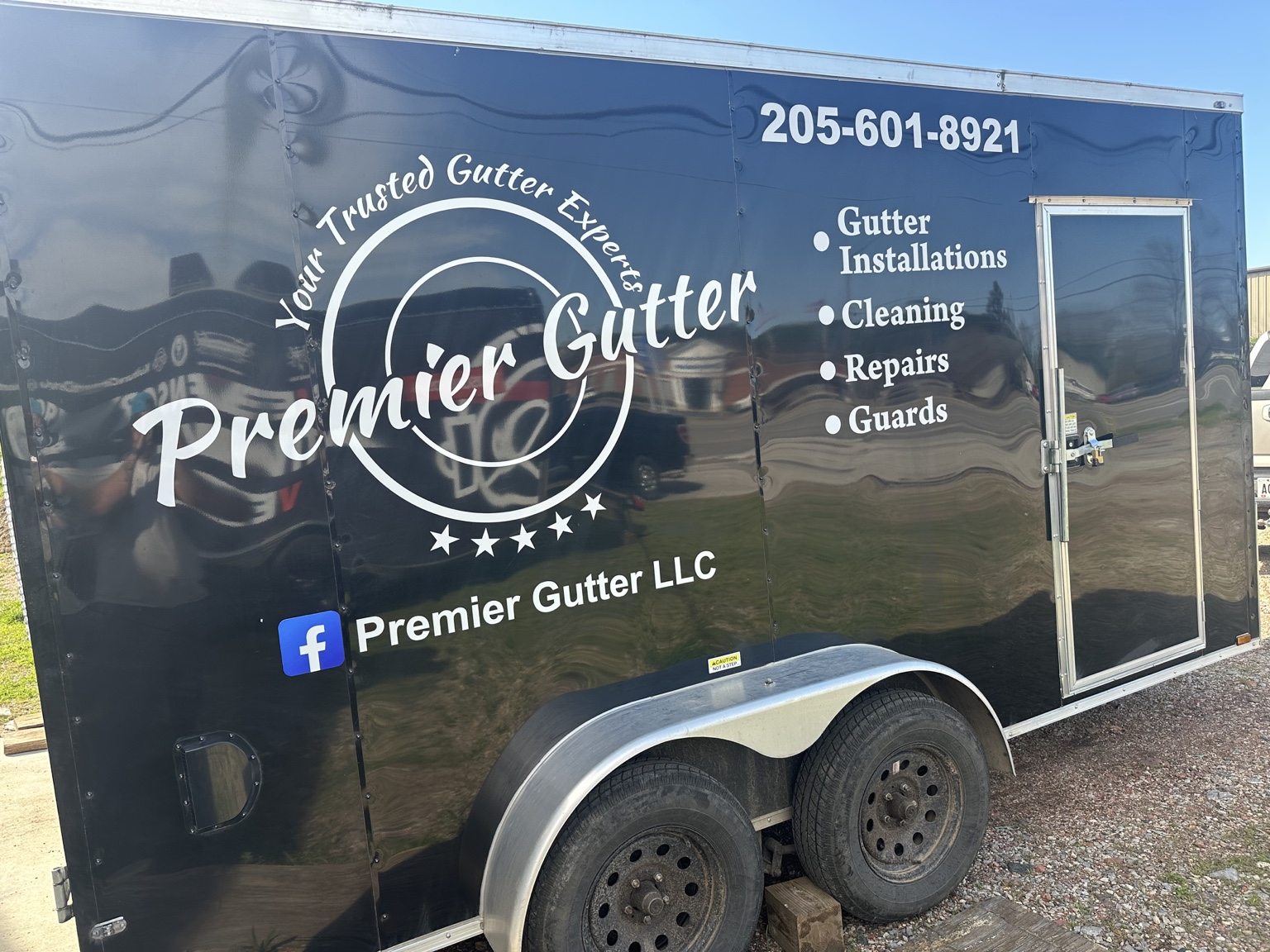 Premier Gutter LLC branded work trailer